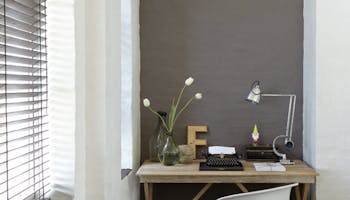 Desk space with a painted arch feature behind